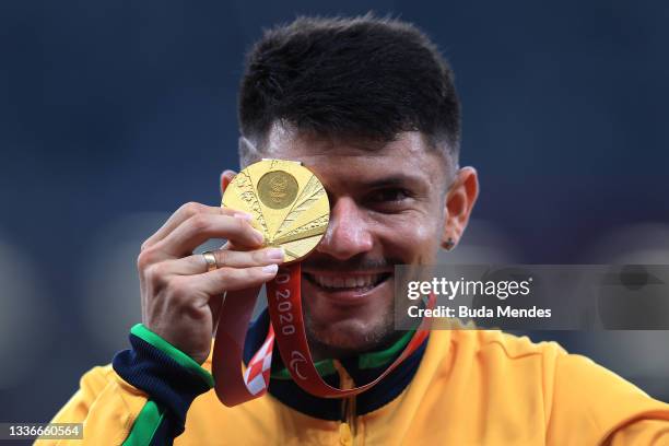 Petrucio Ferreira dos Santos of Team Brazil celebrates with the gold medal during the medal ceremony for the Men's 100m - T47 Final on day 3 of the...