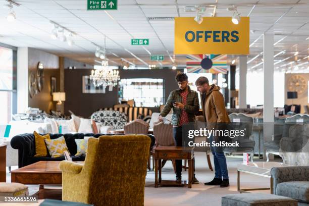 thinking about their purchase - furniture store stockfoto's en -beelden