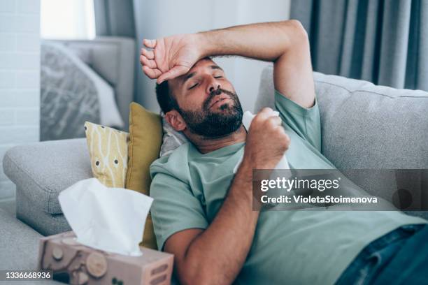 man with high fever at home. - snuit stockfoto's en -beelden