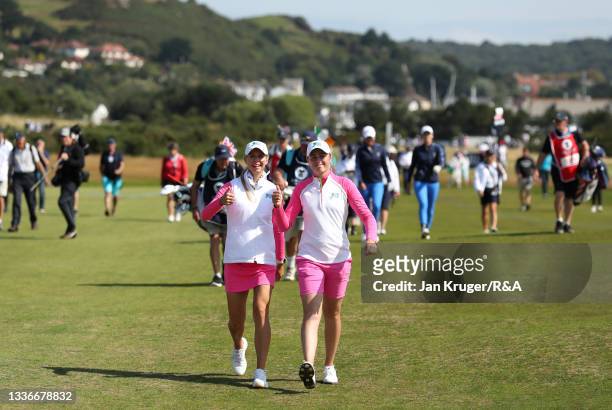 Hannah Darling of Team Great Britain and Ireland and Annabell Fuller of Team Great Britain and Ireland walk on the 2nd fairway during day two of The...