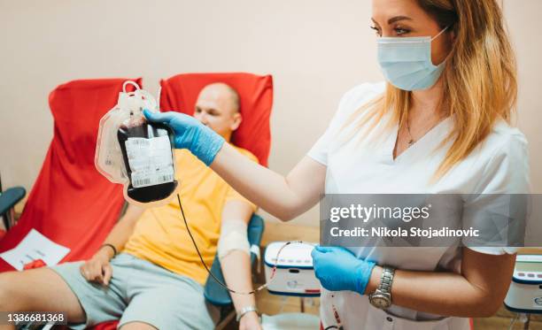 nurse and blood donor - blood bag stock pictures, royalty-free photos & images