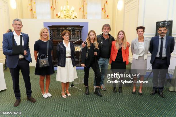 Actors Olivier Marchal and Marie Colomb pose with the jury of the prize in the shape of a cane which symbolizes Vidocq as they attend the "Prix...