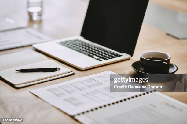 shot of a notebook and laptop in an office - day planner bildbanksfoton och bilder