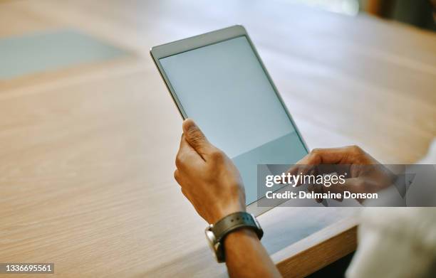 shot of an unrecognizable businessperson using a digital tablet at work - tablet close up real copyspace stock pictures, royalty-free photos & images