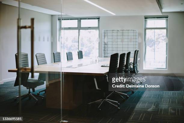 shot of an empty boardroom at work - boardroom stockfoto's en -beelden