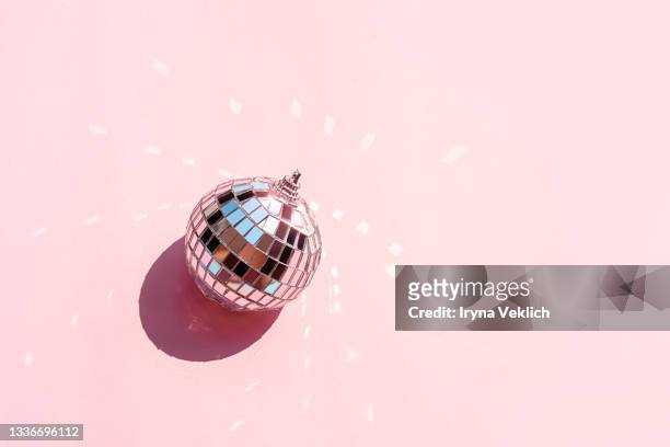 disco ball and baubles on pastel pink background. - diskokugel stock-fotos und bilder