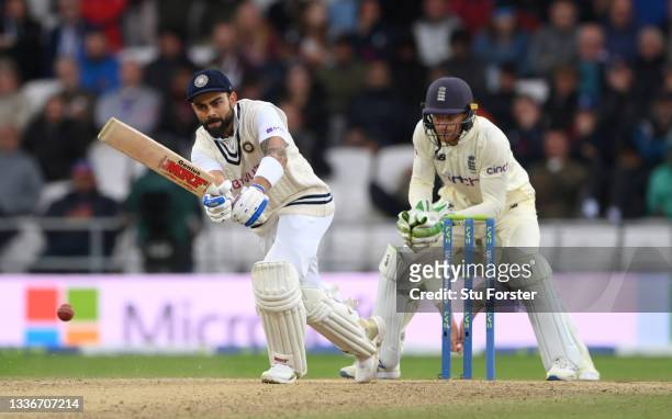 India batsman Virat Kohli picks up ssome runs watched by Jos Buttler during day three of the Third Test Match between England and India at Emerald...