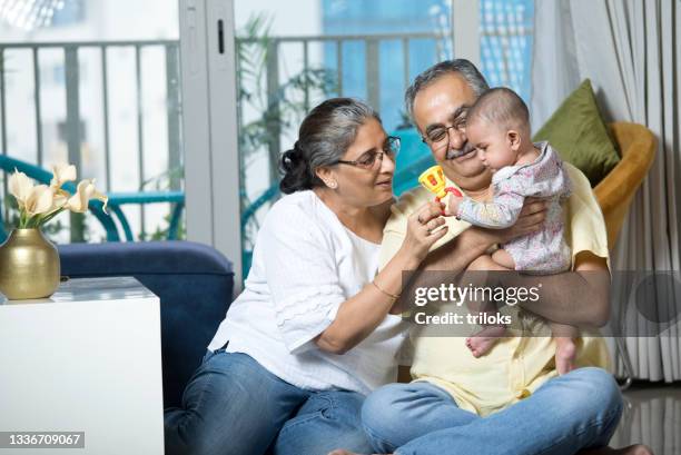 happy grandparents with baby grandson at home - grandson stock pictures, royalty-free photos & images