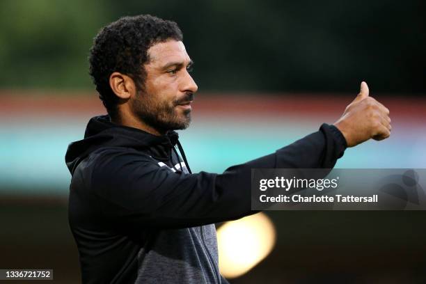 Hayden Mullins, Manager of Colchester United gives a thumbs up to his players during the Sky Bet League Two match between Rochdale and Colchester...