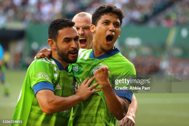 Fredy Montero of Seattle Sounders celebrates with teammates after scoring in the first half to take a 1-0 lead against the Portland Timbers at...