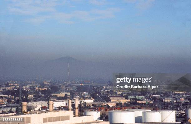 View, across industrial buildings, of air pollution and smog over the city of San Diego, California, February 1991.