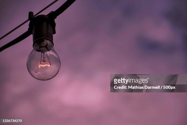 low angle view of light bulb against sky - darmell bildbanksfoton och bilder
