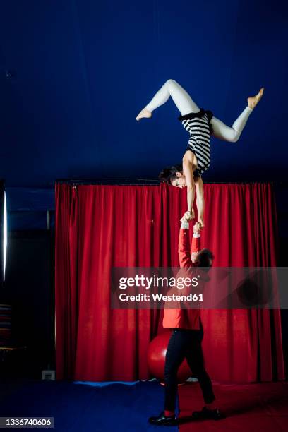 male and female acrobats performing together in circus - circus artist stock pictures, royalty-free photos & images