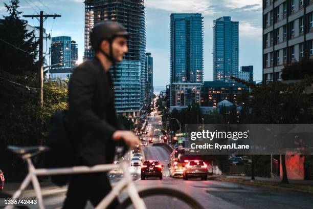 bike riding urban commuter at dusk - seattle city life stock pictures, royalty-free photos & images