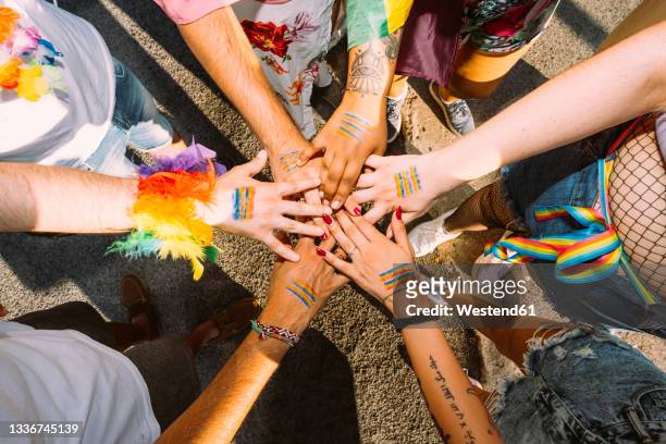 male and female activists with hands clasped on street - lgbt stockfoto's en -beelden