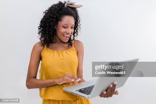 happy young woman using laptop against white background - laptop isolated stock-fotos und bilder