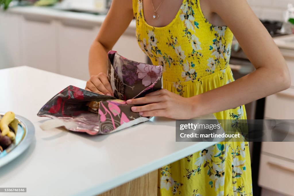 Girl preparing lunch with eco-friendly food wrap.