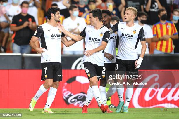 Goncalo Guedes of Valencia CF celebrates with Hugo Guillamon and team mates after scoring their side's third goal during the La Liga Santander match...