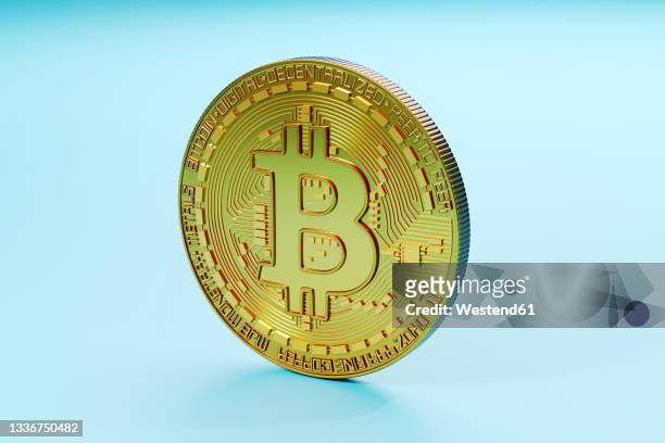 three dimensional render of bitcoin standing against blue background - bitcoin stock pictures, royalty-free photos & images