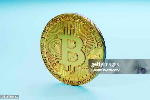 three dimensional render of bitcoin standing against blue background - copper mineral stock pictures, royalty-free photos & images