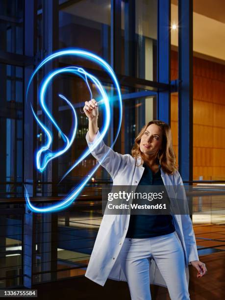 female doctor analyzing ear in laboratory at hospital - human ear stock pictures, royalty-free photos & images