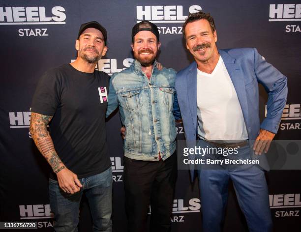 Phil Brooks “CM Punk”, Stephen Amell and David James Elliott pose for a photo during a screening episode of the Starz channel's wrestling drama...