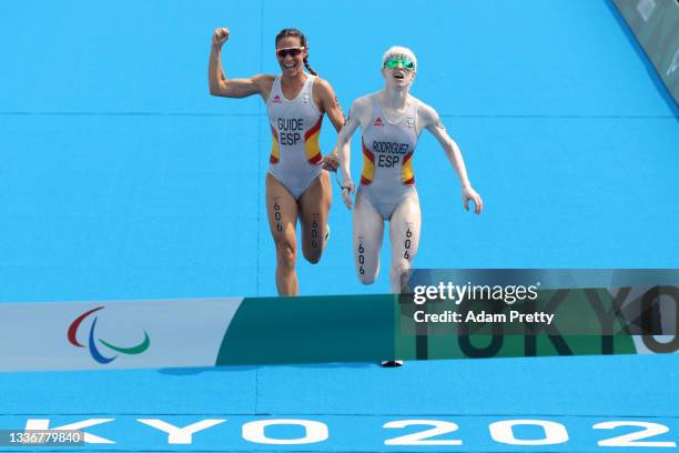 Susana Rodriguez and guide Sara Loehr of Team Spain react as they near the finish line to win the gold medal during the women's PTVI Triathlon on day...