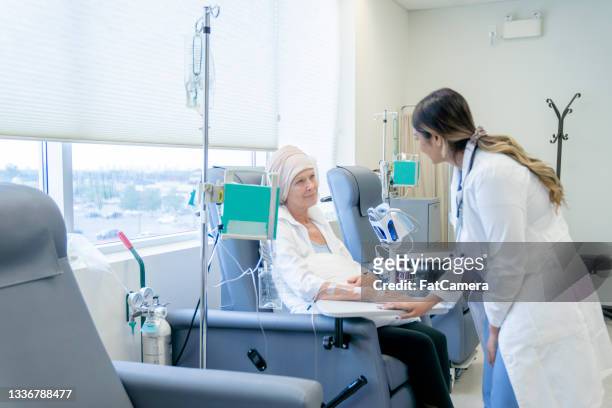 senior woman with cancer talking to a female oncologist - leukemia stock pictures, royalty-free photos & images
