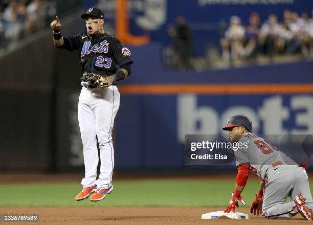 Javier Baez of the New York Mets reacts after Gerardo Parra of the Washington Nationals is initially called safe after a steal attempt in the seventh...