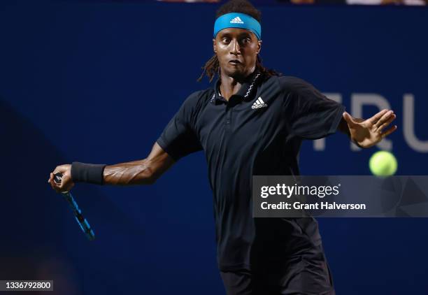 Mikael Ymer of Sweden returns a shot to Carlos Alcaraz of Spain during the semifinals of the Winston-Salem Open at Wake Forest Tennis Complex on...