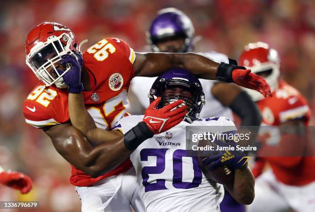 Running back Ito Smith of the Minnesota Vikings and defensive end Tim Ward of the Kansas City Chiefs grab each other's face masks during the second...