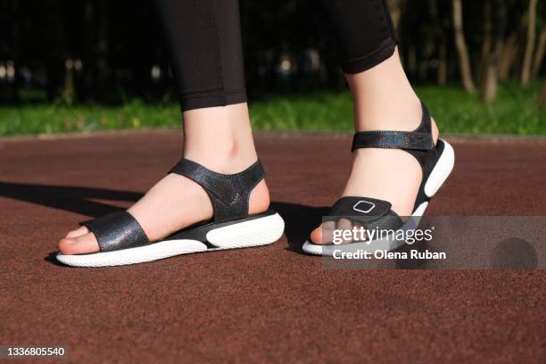 black woman sandals on a sportsground with sun - sandalo stock pictures, royalty-free photos & images