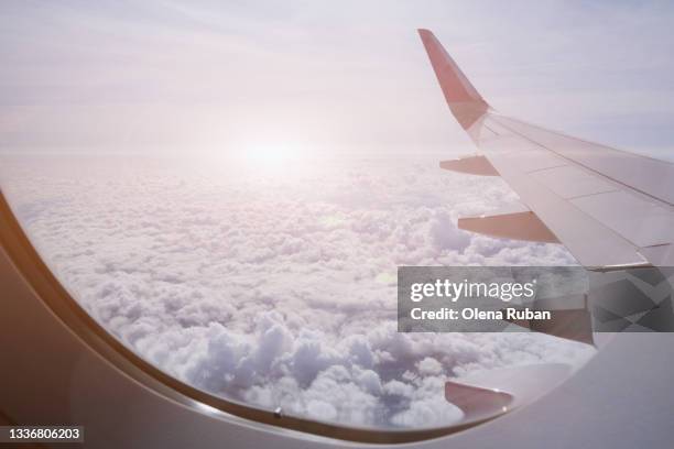 wing of an airplane among beautiful clouds - porthole stock pictures, royalty-free photos & images