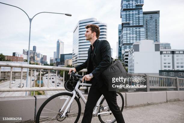 bike riding urban commuter at dusk - seattle city life stock pictures, royalty-free photos & images