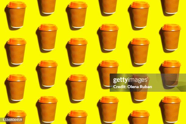 coffee glass with orange lid on yellow desk - plastic design furniture stock pictures, royalty-free photos & images