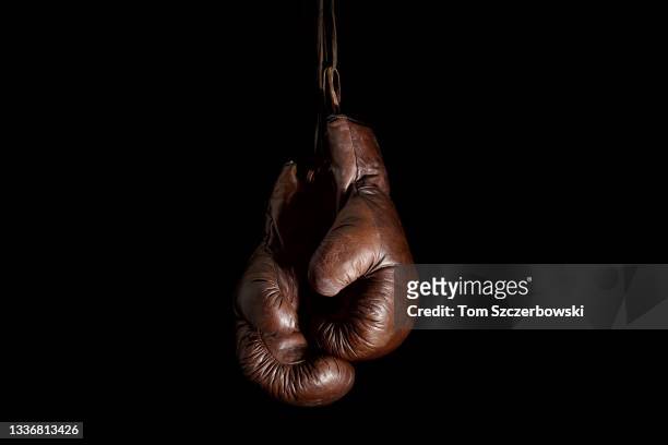 Pair of vintage boxing gloves hangs at a boxing gym on October 15, 2018 in London, Ontario, Canada.