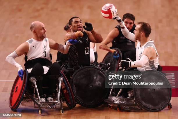 Barney Koneferenisi of New Zealand battles for the ball with Thomas Pagh and Jakob Mortensen of Denmark during their Wheelchair Rugby 7th and 8th...