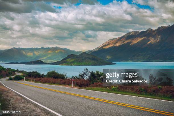 glenorchy-queenstown road - new zealand otago road stock pictures, royalty-free photos & images