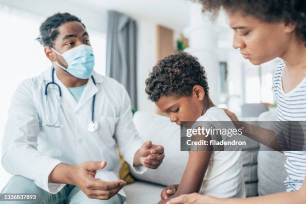 doctor at home visit - african american band aids stock pictures, royalty-free photos & images