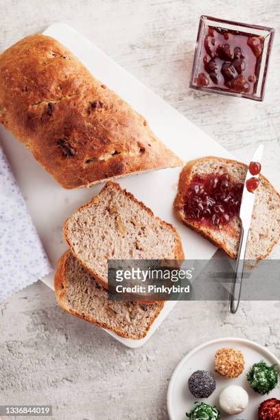 grain artisan bread loaf with jam, grape preserves on bread, homemade baking bread, - marmalade sandwich stock pictures, royalty-free photos & images