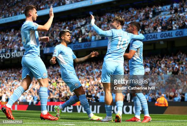 Ferran Torres of Manchester City celebrates with teammates Aymeric Laporte, Joao Cancelo, and Jack Grealish after scoring his team's second goal...