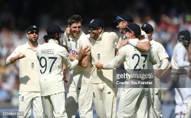 England bowler Craig Overton is congratulated by team mates after taking the final wicket of the innings, Mohammed Siraj during day four of the Third...