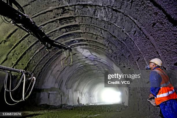 Worker at the contruction site of a tunnel in the east Tianshan mountain, as part of the National Highway G575 on August 27, 2021 in Hami, Xinjiang...