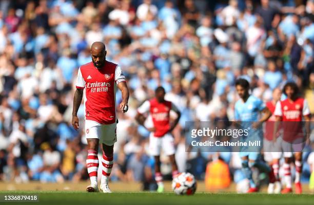Alexandre Lacazette of Arsenal cuts a dejected figure after conceding a fifth goal during the Premier League match between Manchester City and...
