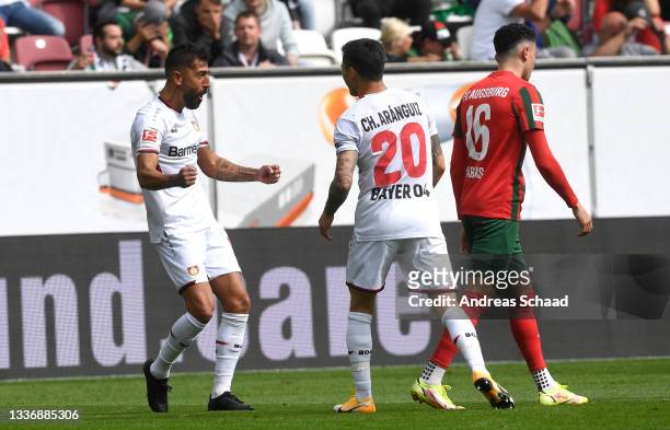 Kerem Demirbay of Bayer 04 Leverkusen celebrates after his team's second goal, an own goal by Florian Niederlechner of FC Augsburg during the...