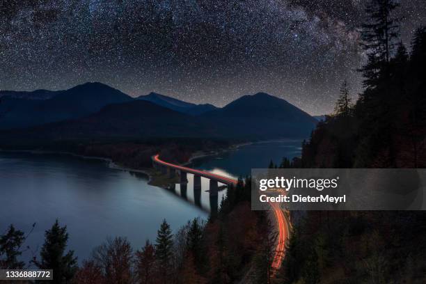 milky way over alpine road in alps - sylvenstein lake bildbanksfoton och bilder