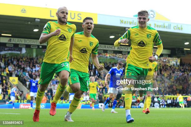 Teemu Pukki of Norwich City celebrates with teammates Milot Rashica and Brandon Williams after scoring his team's first goal during the Premier...