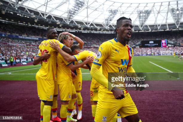 Wilfried Zaha of Crystal Palace celebrates, as Conor Gallagher of Crystal Palace celebrates with teammates after scoring his team's second goal...