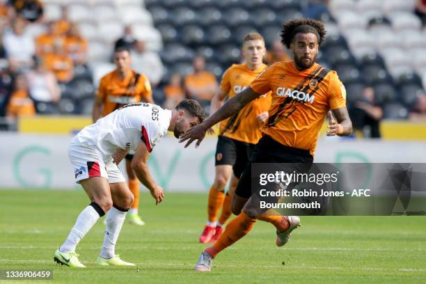 Emiliano Marcondes of Bournemouth is beaten by Tom Huddlestone of Hull City during the Sky Bet Championship match between Hull City and AFC...