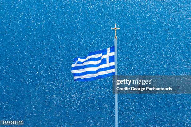 greek flag with the aegean sea in the background - greek flag stock pictures, royalty-free photos & images